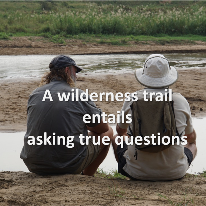 Twee mannen zitten bij een rivier met de tekst 'A wilderness trail entails asking true questions'
